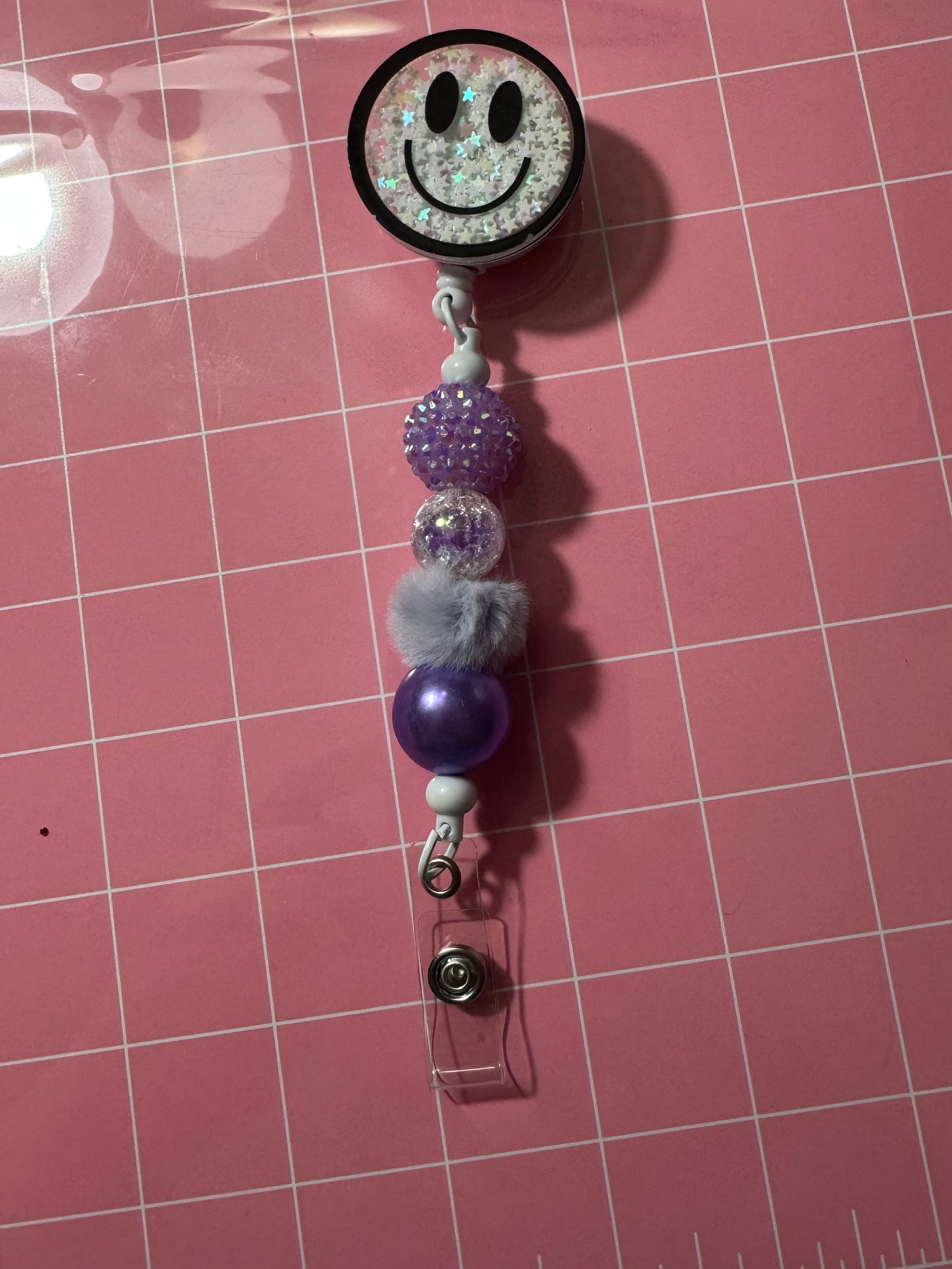 WHITE SMILEY BADGE REEL